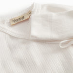 White long-sleeved pointelle onesie with a snap closure for newborns