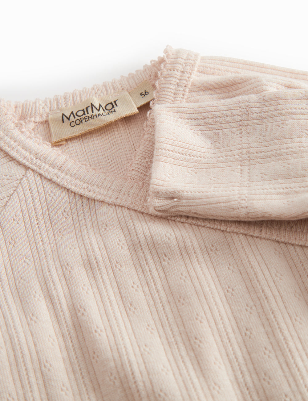 Red long-sleeved pointelle onesie with a front closure for newborns.