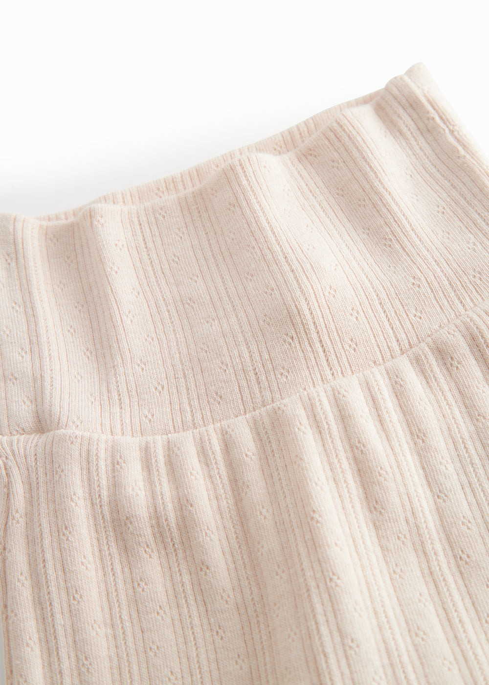 Red polka-dot pants with feet for a newborn baby.