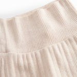 Red polka-dot pants with feet for a newborn baby.