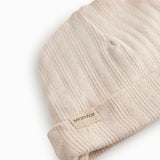 The baby hat in red with a contrasting edge.