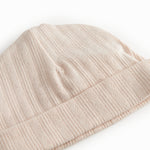 The baby hat in red with a contrasting edge.