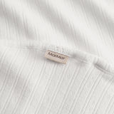 White cotton baby blanket with rounded corners and picot edges.