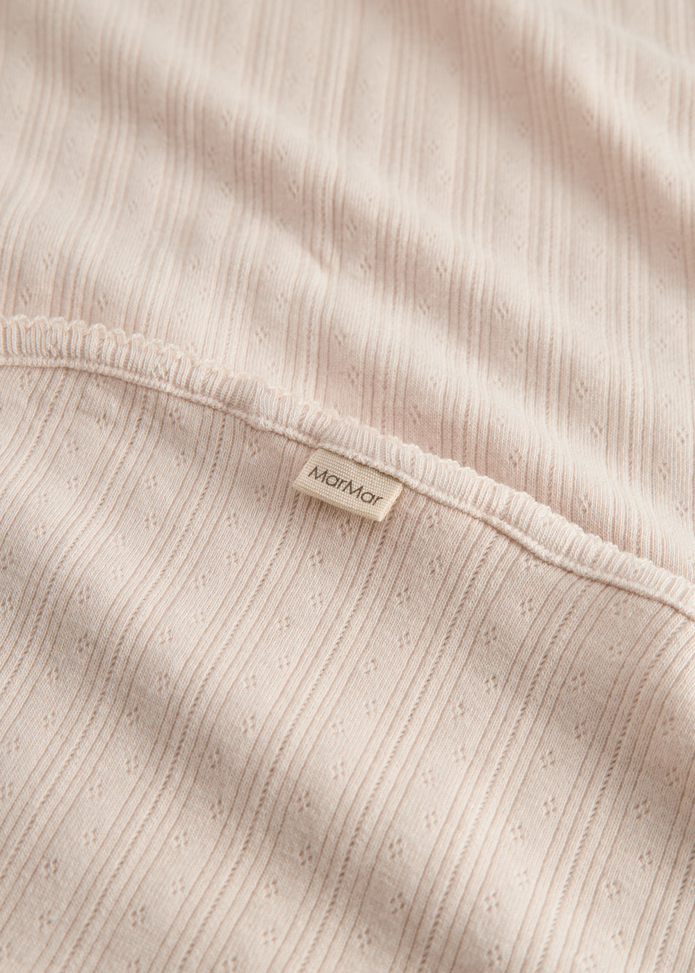 Red polka dot baby blanket with rounded corners and picot edges.