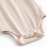 Red baby bodystocking without sleeves with garters