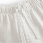White pinstripe baby pants with elastic and a decorative band at the waist.