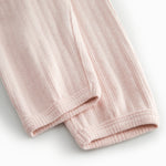 Red polka-dot baby pants with elastic and a decorative band at the waist.