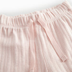 Red polka-dot baby pants with elastic and a decorative band at the waist.