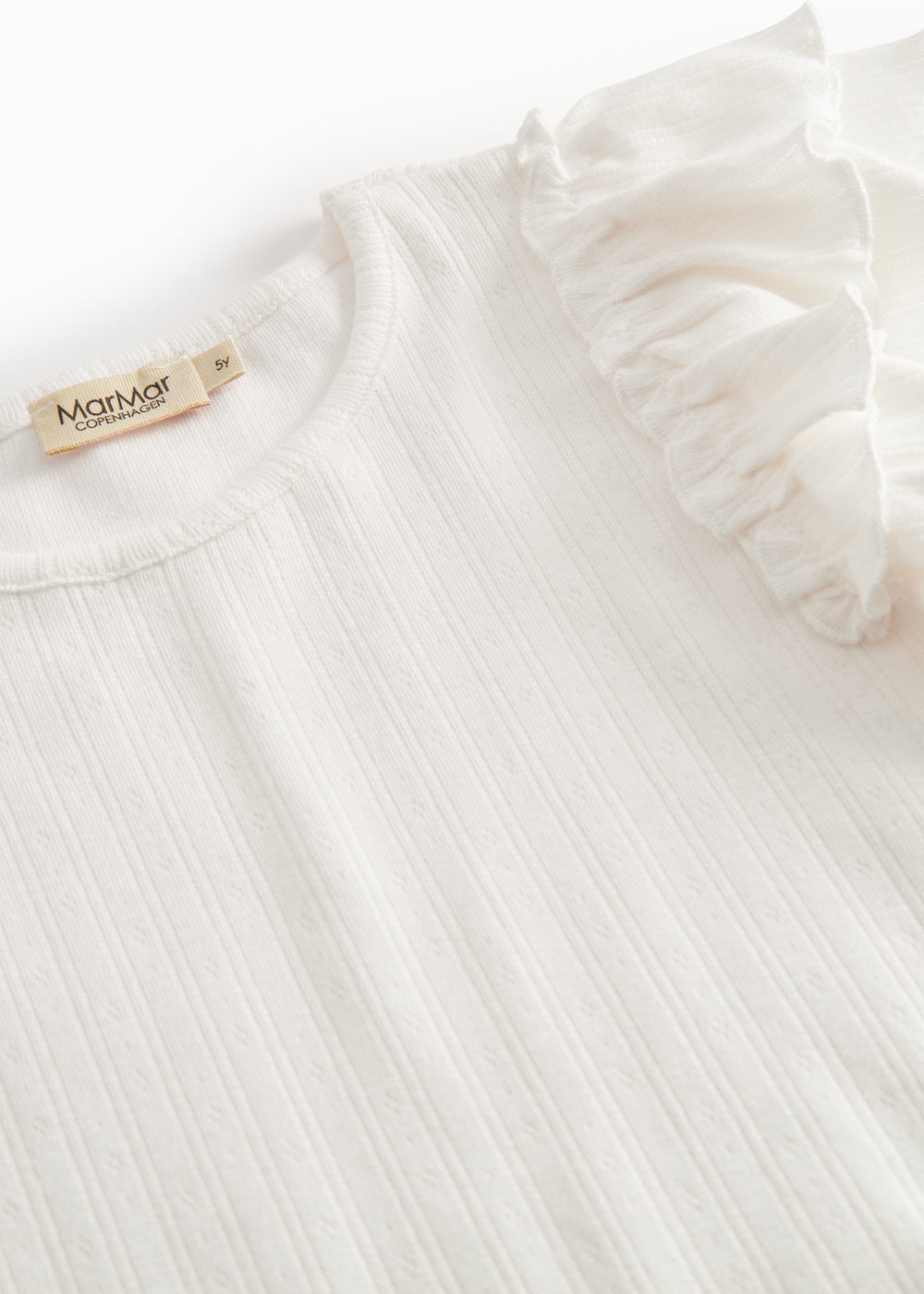 Short-sleeved white polka dot t-shirt for children with cuffs on the sleeves.