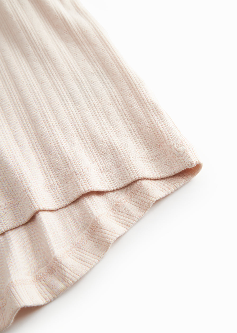 Short-sleeved bright pink polka dot t-shirt for children with cuffs on the sleeves.