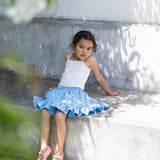 Children wearing blue pants with a floral print