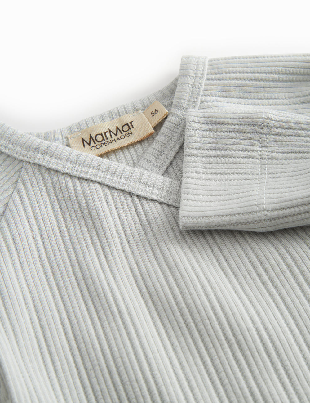 Light green pointelle blouse for newborns with a wrap-around closure.