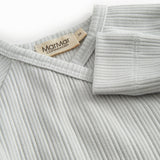 Light green pointelle blouse for newborns with a wrap-around closure.