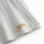 Light green pointelle blouse for newborns with a wrap-around closure.