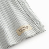 Light green pointelle blouse for newborns with a wrap-around closure.