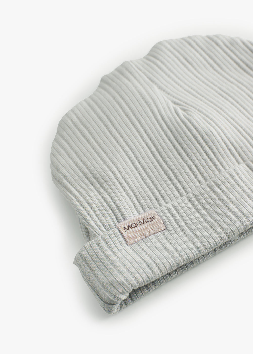 The baby hat in light green with a folded edge.