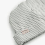 The baby hat in light green with a folded edge.