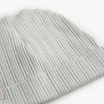 The baby hat in light green with a folded edge.