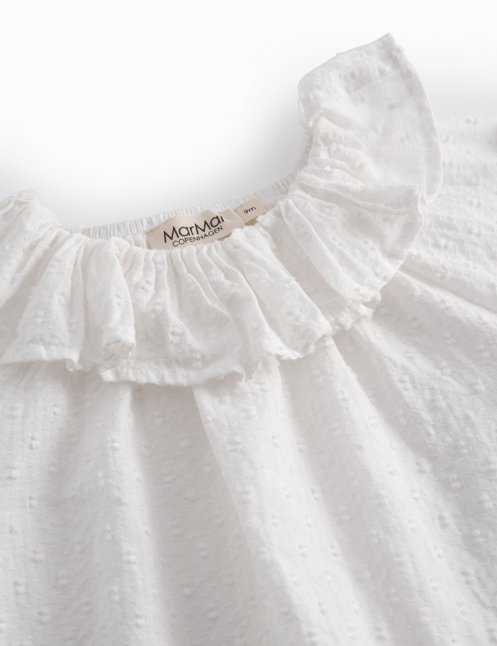 White baby bodysuit with a patterned design and collar