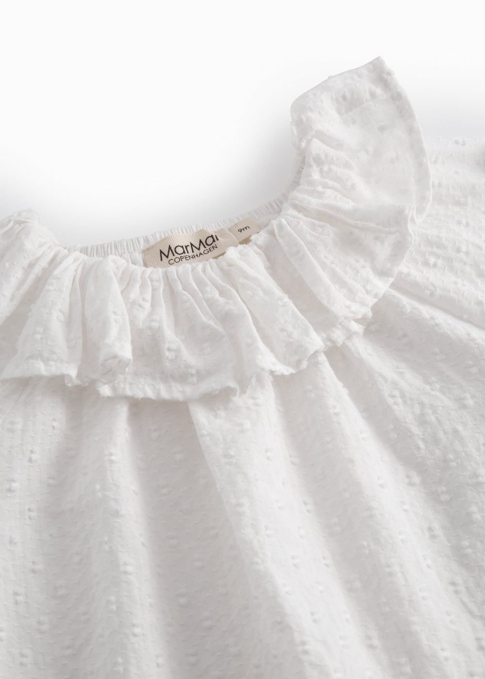 White baby bodysuit with a patterned design and collar