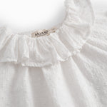 White baby bodysuit with a patterned design and collar