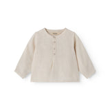 Sleeveless beige top for baby with ruffle details.
