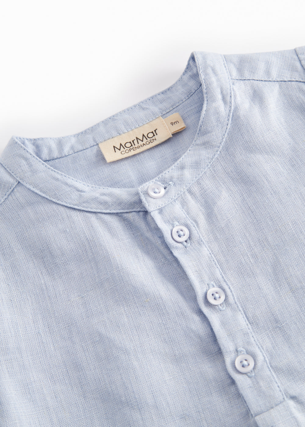 Light blue shorts for children with buttons upfront and a back back.