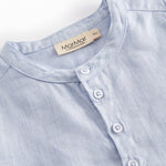 Light blue shorts for children with buttons upfront and a back back.