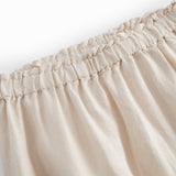 Beige pants for baby with loose fit and elastic in the waist.