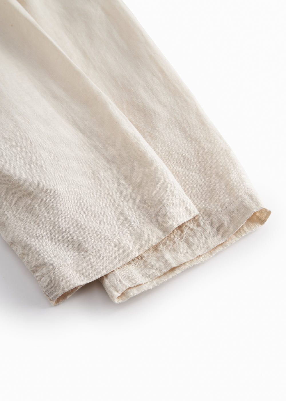 Beige pants for baby with loose fit and elastic in the waist.