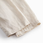 Beige pants for baby with loose fit and elastic in the waist.