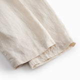 Beige pants for baby with loose fit and elastic in the waist.