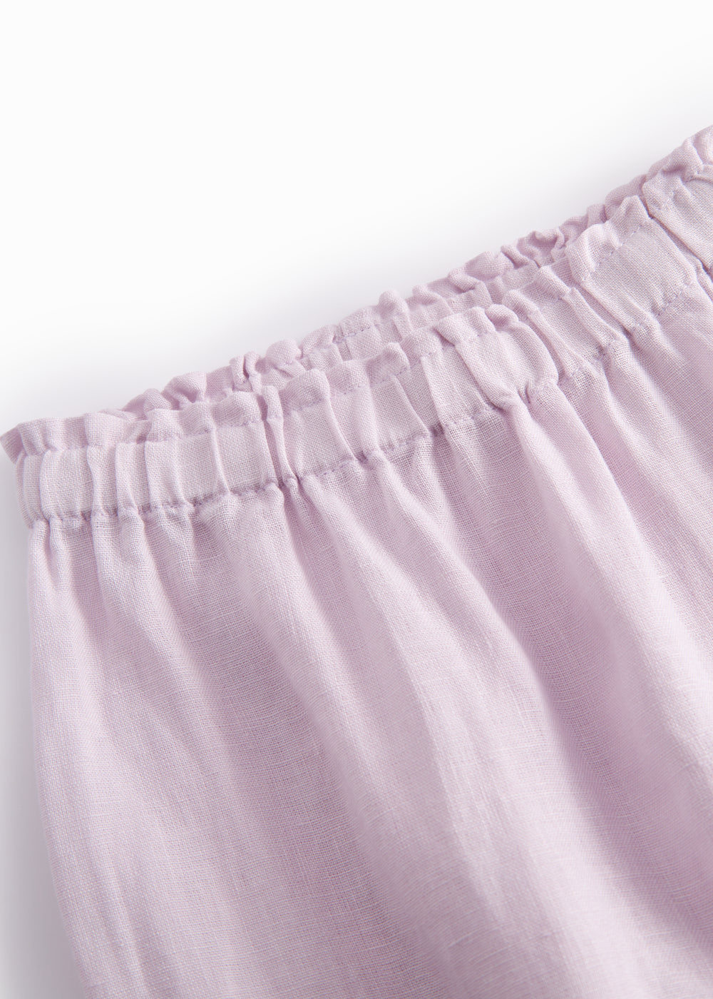 Light pink baby pants with a loose fit and elastic waist.
