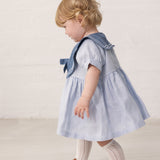 Baby short-sleeved dress with a fine sailor collar and bow at the front.
