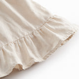 Ærmeløs beige top til baby med flæsedetaljer