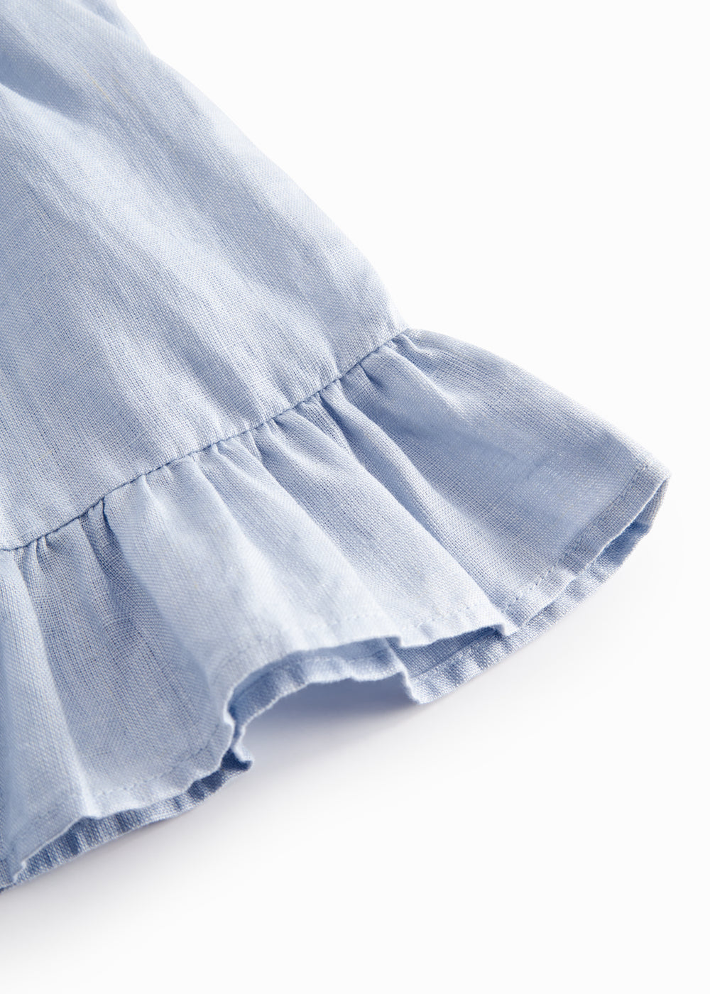 Ærmeløs top til baby med flæsedetaljer