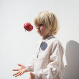 Child wearing a beige shirt with buttons