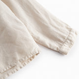 Beige long-sleeved shirt for children with a Mandarin collar and front button-up.