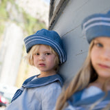 Children wearing matroshkas and sailor-inspired outfits.