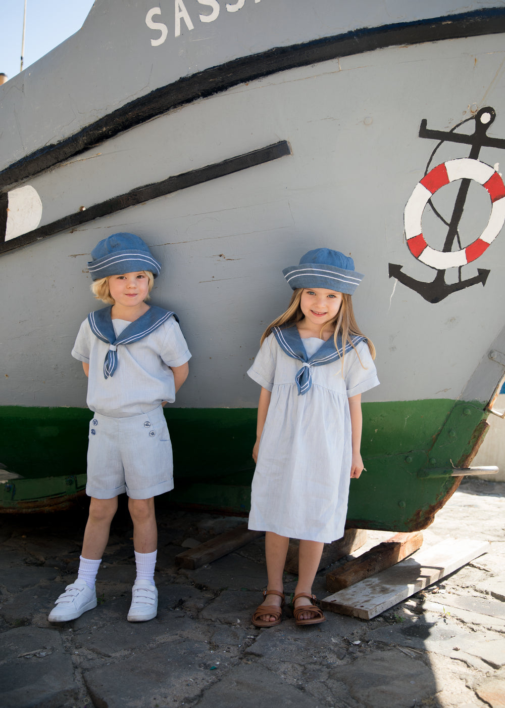 Children wearing matroshkas and sailor-inspired outfits.