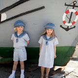 Children wearing matroshkas and sailor-inspired outfits.
