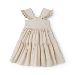 Sleeveless beige dress for children with wide straps and flaps on the shoulder and a smock at the back.