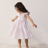 Wearing a sleeveless bright red dress.