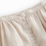 Beige nederdel til børn med sidelommer og knapper