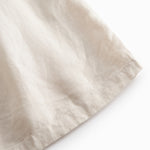 Beige hooded jacket for children with pockets and buttons.