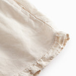 Beige shorts for children with pockets and side pockets.