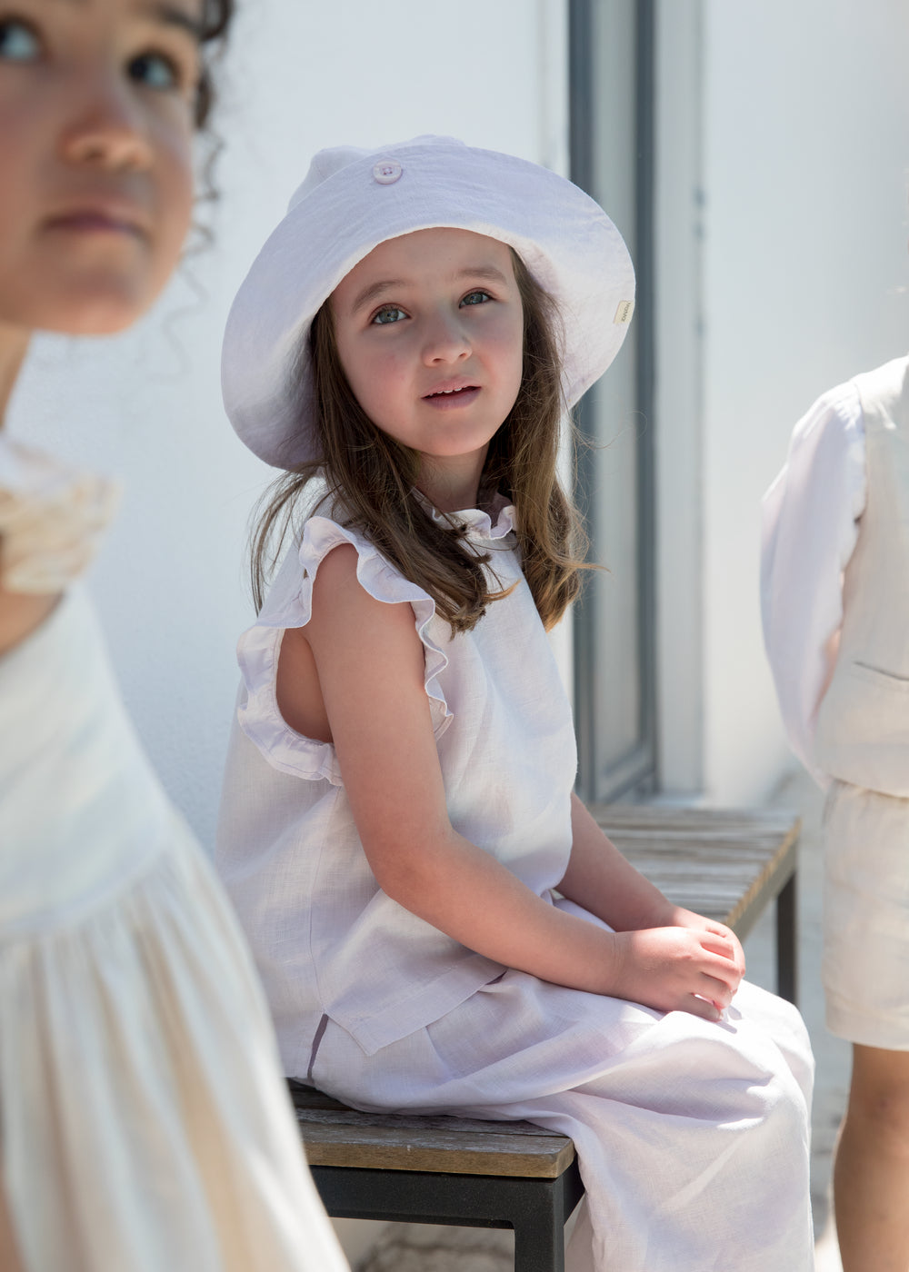 Child wearing a summer hat and a light dress