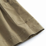 Sleeveless green chino dress for children with buttons.