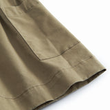 Sleeveless green chino dress for children with buttons.