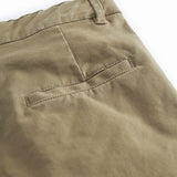 Green chino pants for children with pockets and wide elastic at the waist.